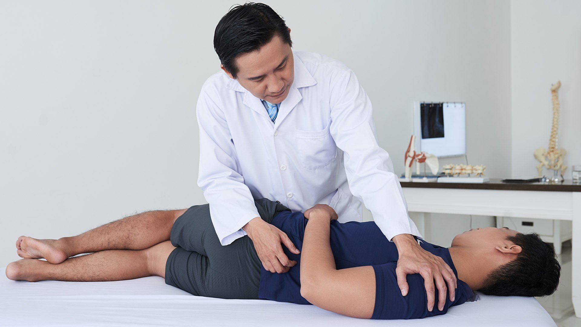 Chiropractor performing spinal adjustment